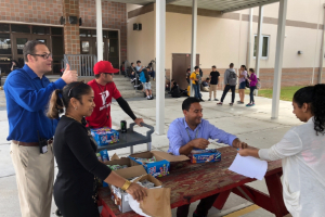 Administration handing out ice cream to students.